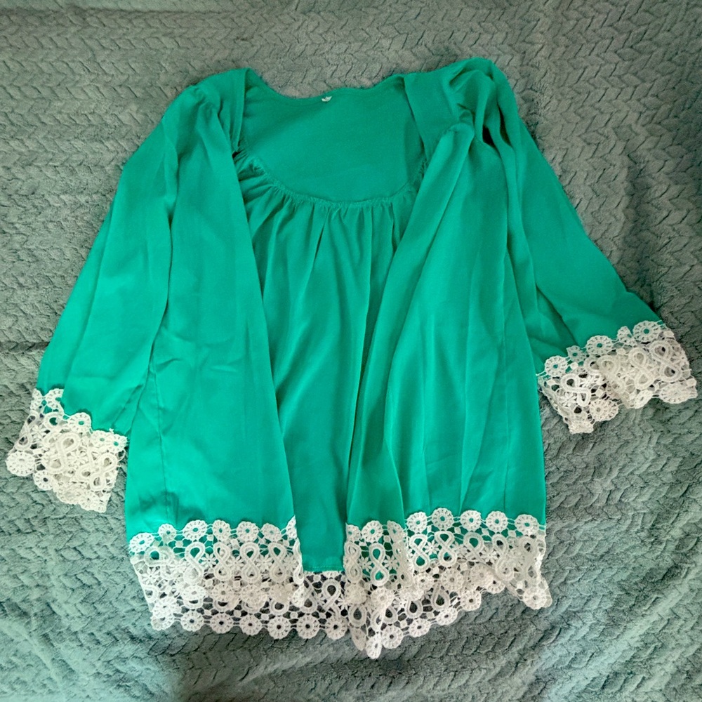 Partially sheer cover up with lace accented sleeves and bottom